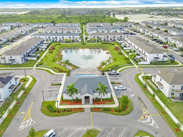 birds eye view of property with a residential view and a water view