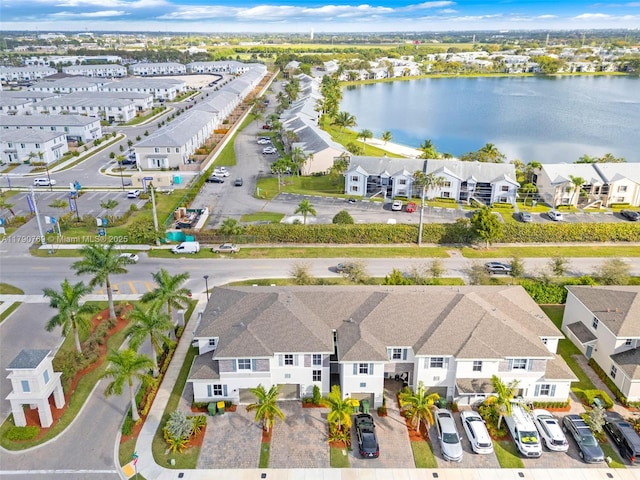 birds eye view of property with a water view and a residential view