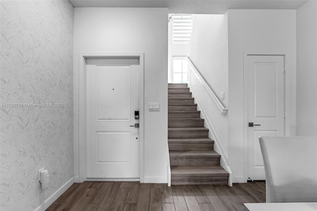 foyer entrance with wood finished floors and stairs