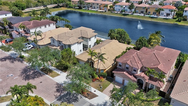 birds eye view of property with a water view and a residential view