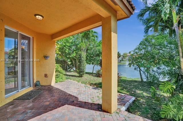 view of patio with a water view
