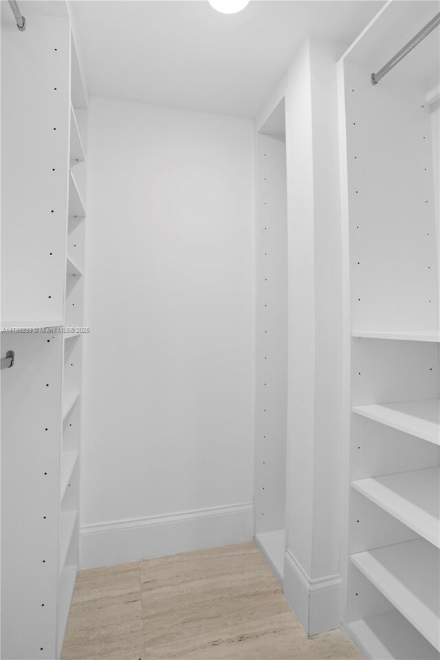 9261 E Bay Harbor Dr Unit 606, Bay Harbor Islands, FL 33154 - walk in closet featuring wood finished floors