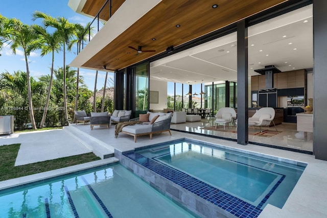 view of swimming pool featuring an outdoor hangout area, a patio, ceiling fan, and a pool with connected hot tub