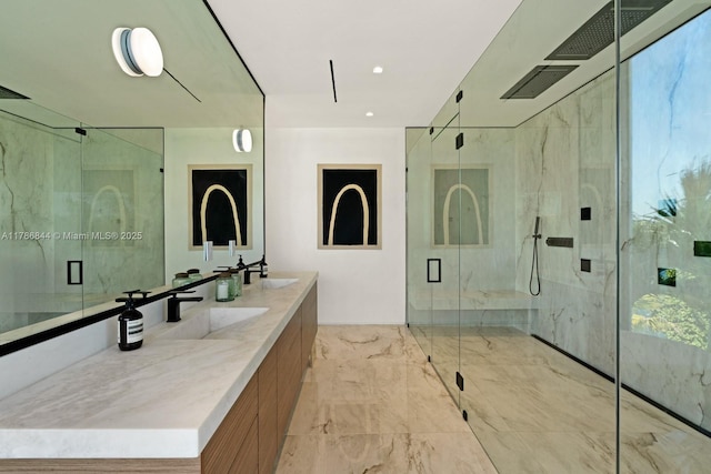 bathroom featuring double vanity, marble finish floor, a sink, visible vents, and a marble finish shower