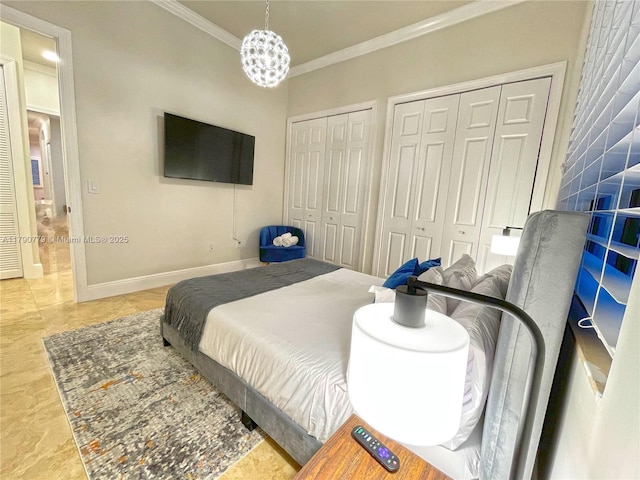 bedroom with crown molding, two closets, and baseboards