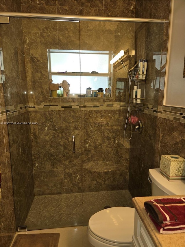 full bath with tile walls, a stall shower, and toilet