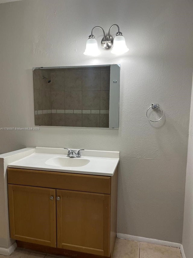 bathroom with tile patterned floors, vanity, and baseboards
