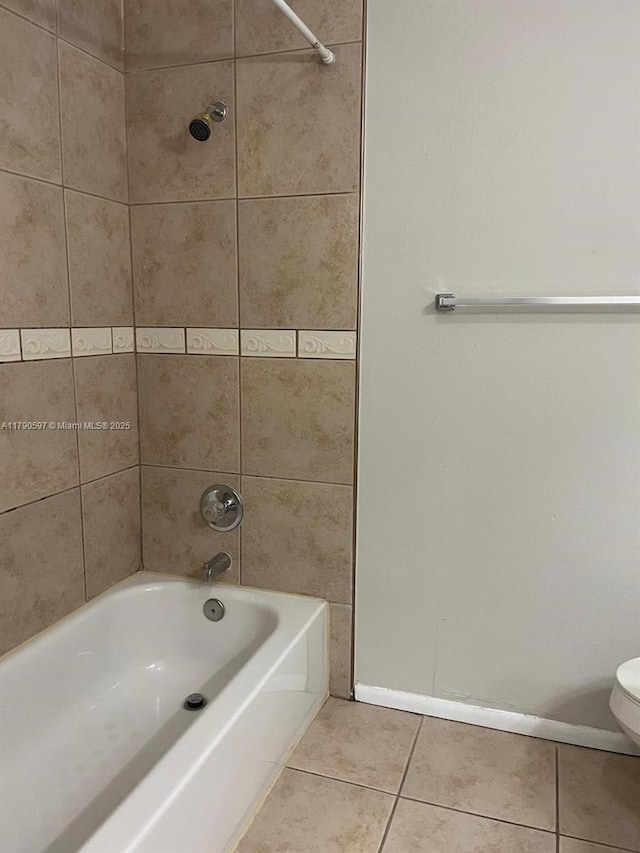 full bath featuring tile patterned floors, baseboards, toilet, and  shower combination
