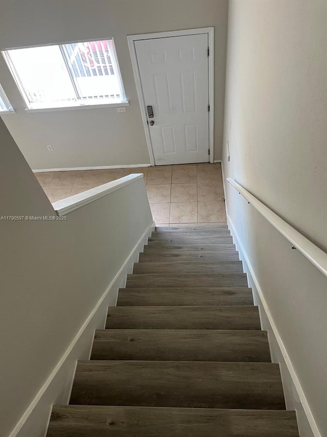 stairs with tile patterned floors