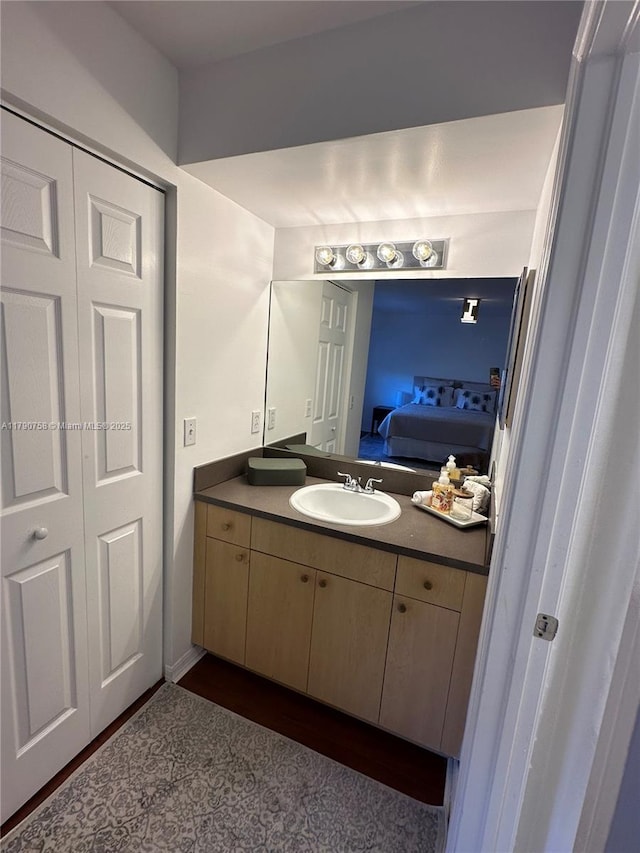 ensuite bathroom featuring connected bathroom and vanity