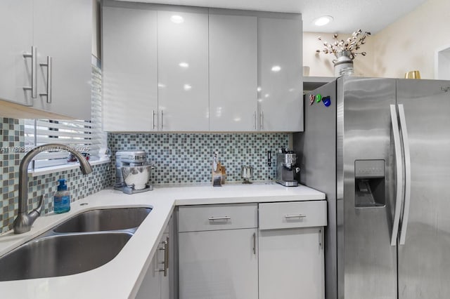 371 Fairway Cir Unit 56, Weston, FL 33326 - kitchen with stainless steel refrigerator with ice dispenser, backsplash, light countertops, and a sink