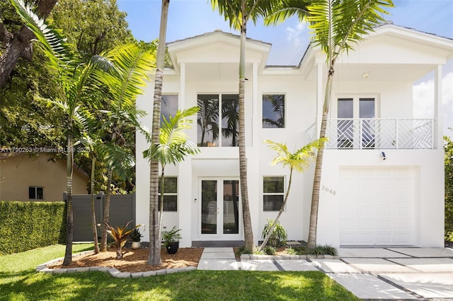 3648 Oak Ave, Coconut Grove, FL 33133 - view of front of house with a garage, french doors, stucco siding, and driveway