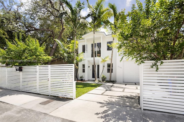 3648 Oak Ave, Coconut Grove, FL 33133 - neoclassical / greek revival house featuring fence, stucco siding, driveway, and a garage