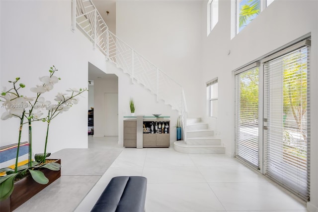 3648 Oak Ave, Coconut Grove, FL 33133 - entryway with tile patterned flooring, stairs, and a high ceiling