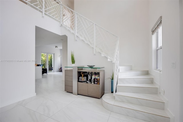 3648 Oak Ave, Coconut Grove, FL 33133 - stairs with baseboards and a high ceiling