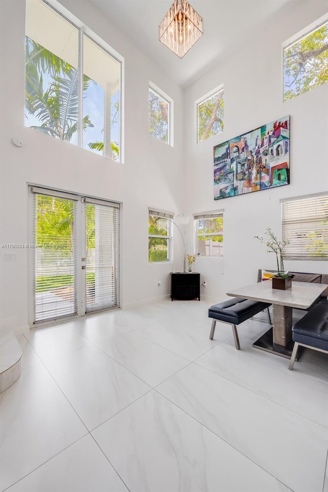3648 Oak Ave, Coconut Grove, FL 33133 - tiled living area featuring baseboards, a wealth of natural light, french doors, and a towering ceiling
