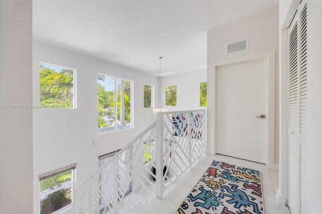 3648 Oak Ave, Coconut Grove, FL 33133 - hallway with a wealth of natural light, visible vents, and an upstairs landing