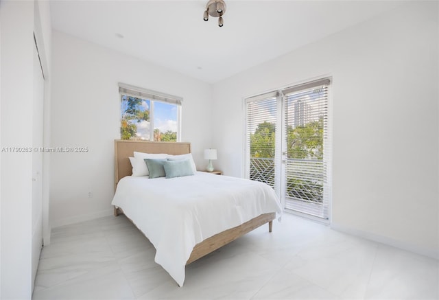 3648 Oak Ave, Coconut Grove, FL 33133 - bedroom with baseboards and access to exterior