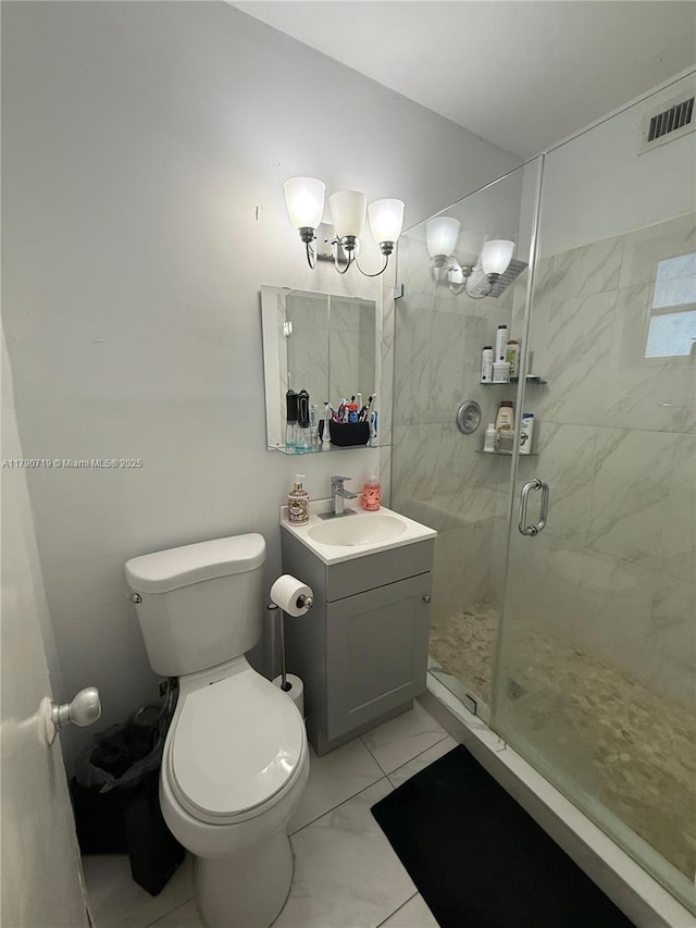full bathroom with a shower stall, marble finish floor, toilet, vanity, and visible vents