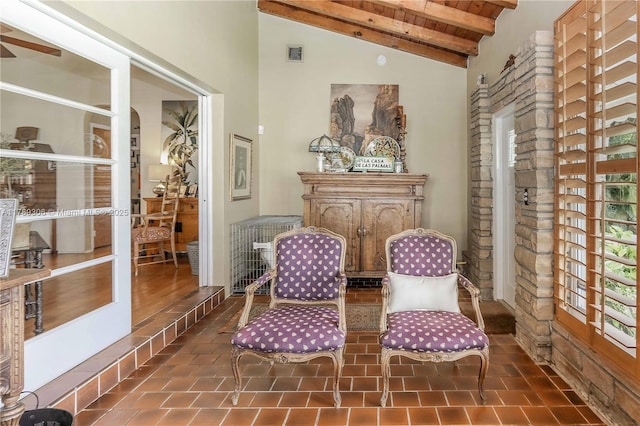 living area featuring visible vents, beamed ceiling, high vaulted ceiling, and plenty of natural light