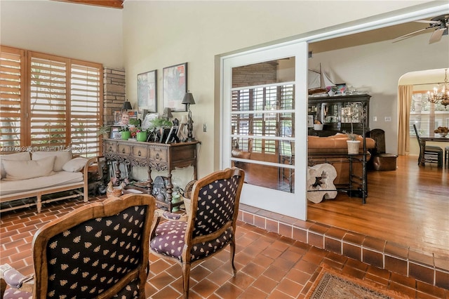 interior space featuring ceiling fan with notable chandelier and a wealth of natural light