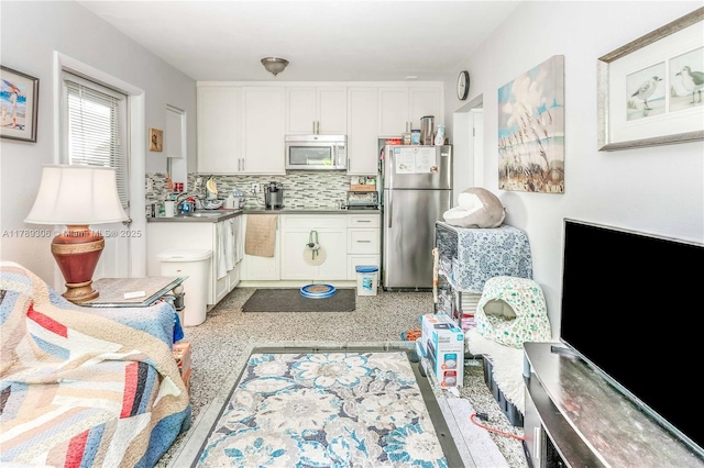 kitchen featuring white cabinetry, tasteful backsplash, appliances with stainless steel finishes, and a sink