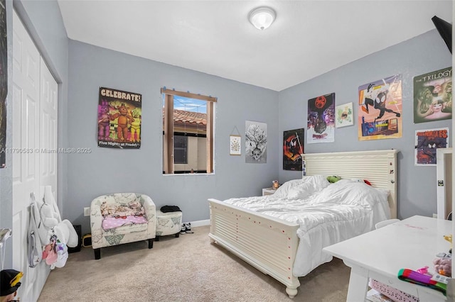 carpeted bedroom with baseboards and a closet