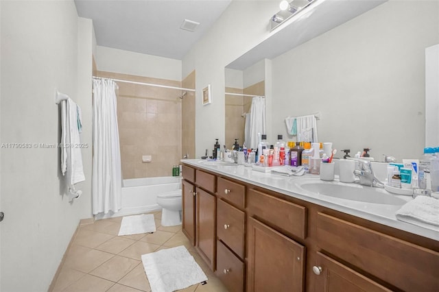 full bathroom featuring a sink, tile patterned flooring, visible vents, and double vanity