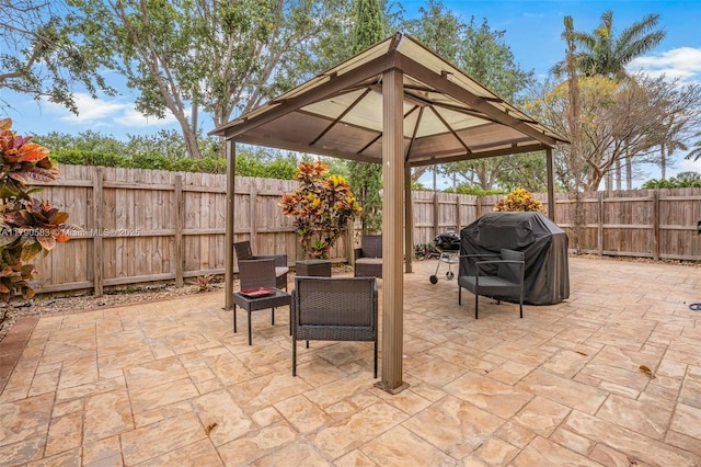 view of patio featuring a gazebo, grilling area, and a fenced backyard