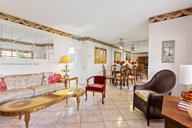 5300 Washington St Unit J116, Hollywood, FL 33021 - living room with light tile patterned floors, ceiling fan, and visible vents