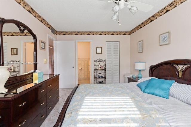 5300 Washington St Unit J116, Hollywood, FL 33021 - bedroom featuring light tile patterned floors, connected bathroom, arched walkways, a closet, and a ceiling fan