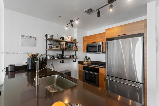 kitchen with stainless steel appliances, open shelves, dark countertops, a sink, and visible vents