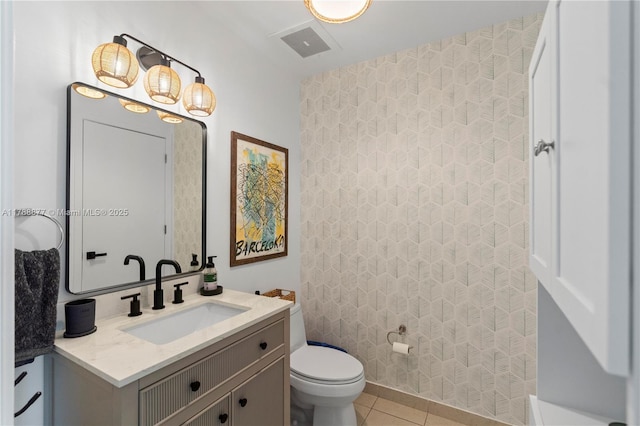 bathroom featuring tile patterned floors, visible vents, toilet, and vanity