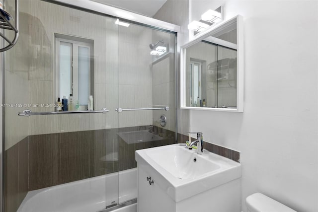 11105 NE 9th Ave, Biscayne Park, FL 33161 - full bathroom featuring vanity, bath / shower combo with glass door, and toilet