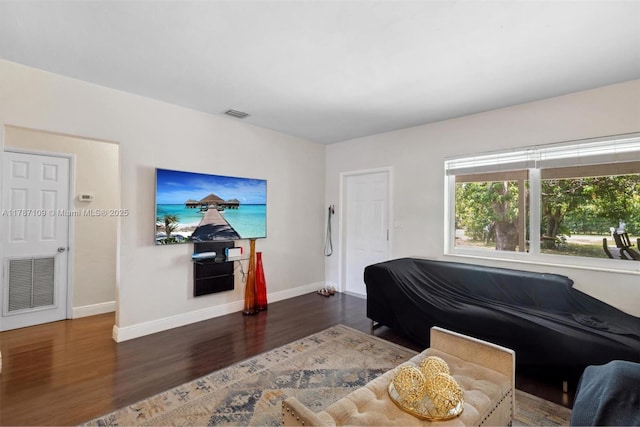 11105 NE 9th Ave, Biscayne Park, FL 33161 - living area with baseboards, wood finished floors, and visible vents
