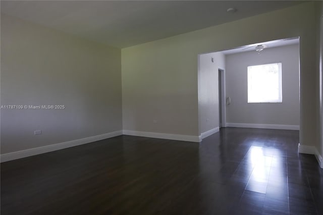 11105 NE 9th Ave, Biscayne Park, FL 33161 - unfurnished room with baseboards, dark wood finished floors, and ceiling fan
