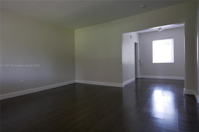 11105 NE 9th Ave, Biscayne Park, FL 33161 - unfurnished room with baseboards, dark wood finished floors, and ceiling fan