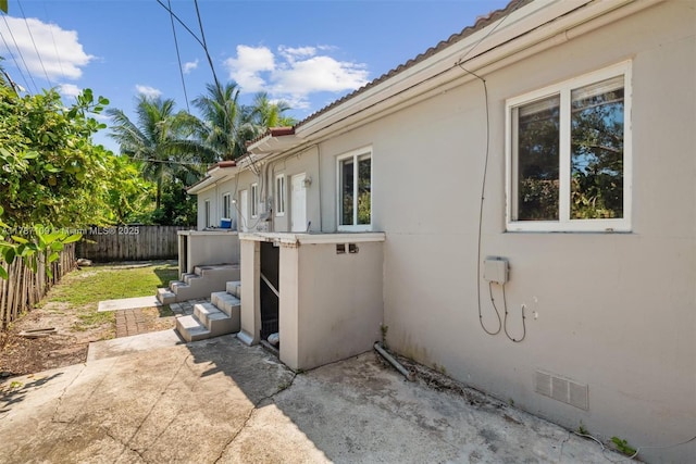 11105 NE 9th Ave, Biscayne Park, FL 33161 - view of property exterior with a fenced backyard, stucco siding, and a tiled roof
