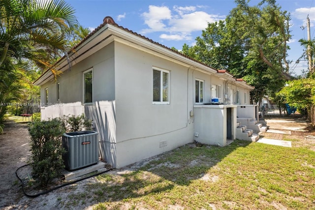 11105 NE 9th Ave, Biscayne Park, FL 33161 - view of property exterior featuring a yard, central AC, and crawl space