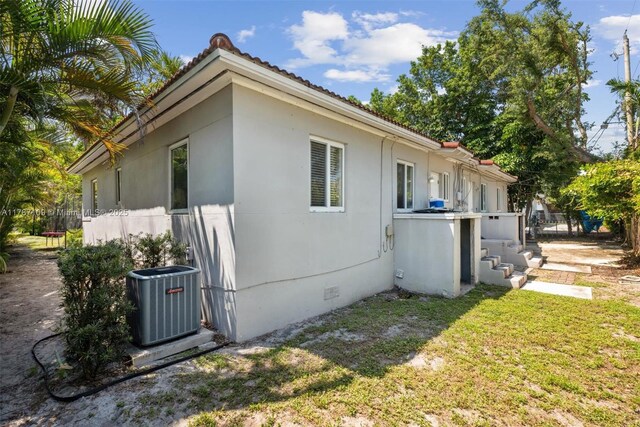11105 NE 9th Ave, Biscayne Park, FL 33161 - view of property exterior featuring a yard, central AC, and crawl space