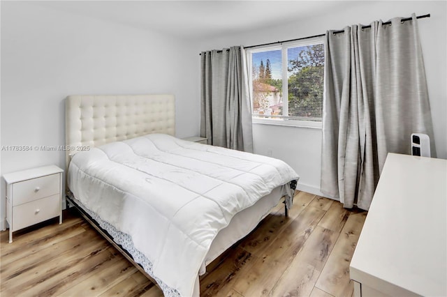 bedroom featuring light wood-style floors