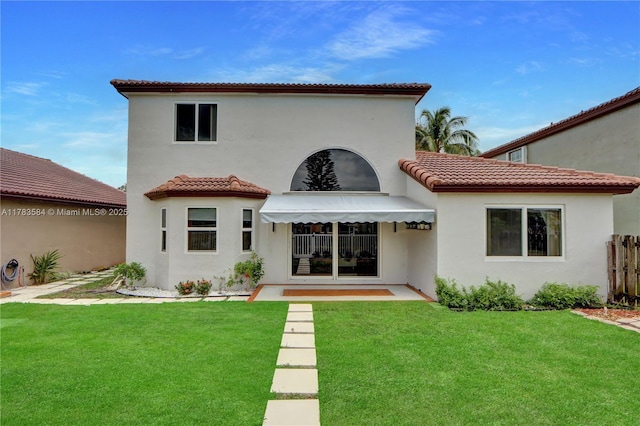 rear view of house with stucco siding and a tiled roof