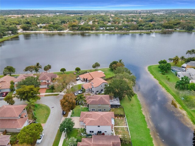 drone / aerial view with a water view and a residential view
