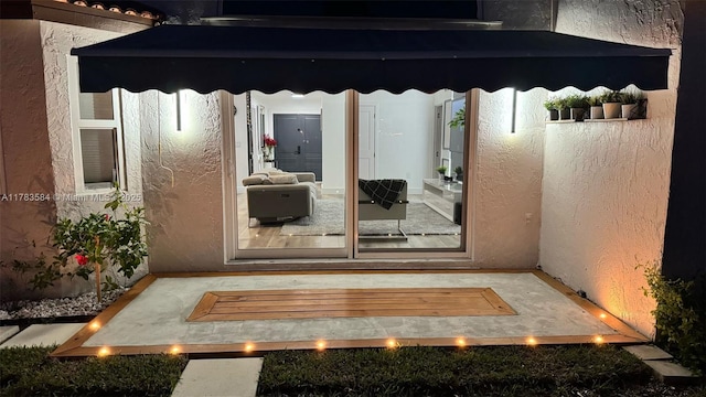 entrance to property with stucco siding