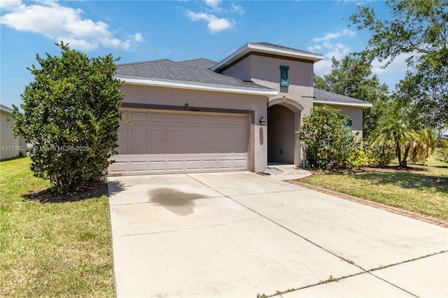 10860 79th St, E, FL 34219 - view of front of property featuring a garage, a front lawn, stucco siding, and driveway