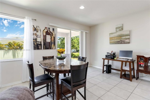 10860 79th St, E, FL 34219 - dining room with light tile patterned floors, recessed lighting, and baseboards