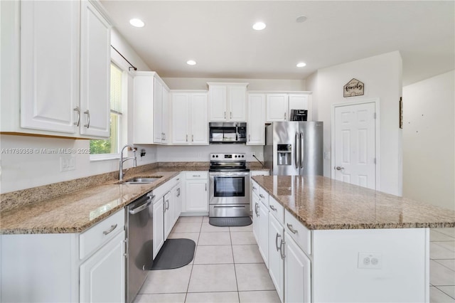 10860 79th St, E, FL 34219 - kitchen featuring white cabinetry, a center island, appliances with stainless steel finishes, and a sink