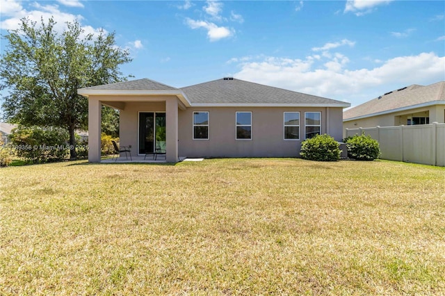 10860 79th St, E, FL 34219 - back of property with fence, a patio area, stucco siding, and a lawn