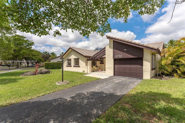 9130 SW 101st Ave, Miami, FL 33176 - view of front facade with aphalt driveway, a tiled roof, a front yard, an attached garage, and stucco siding
