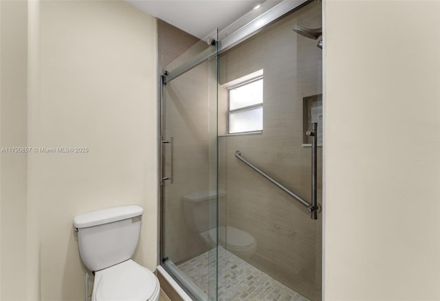 full bath with a shower stall and toilet